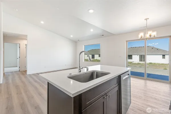 a kitchen with kitchen island white cabinets and stainless steel appliances