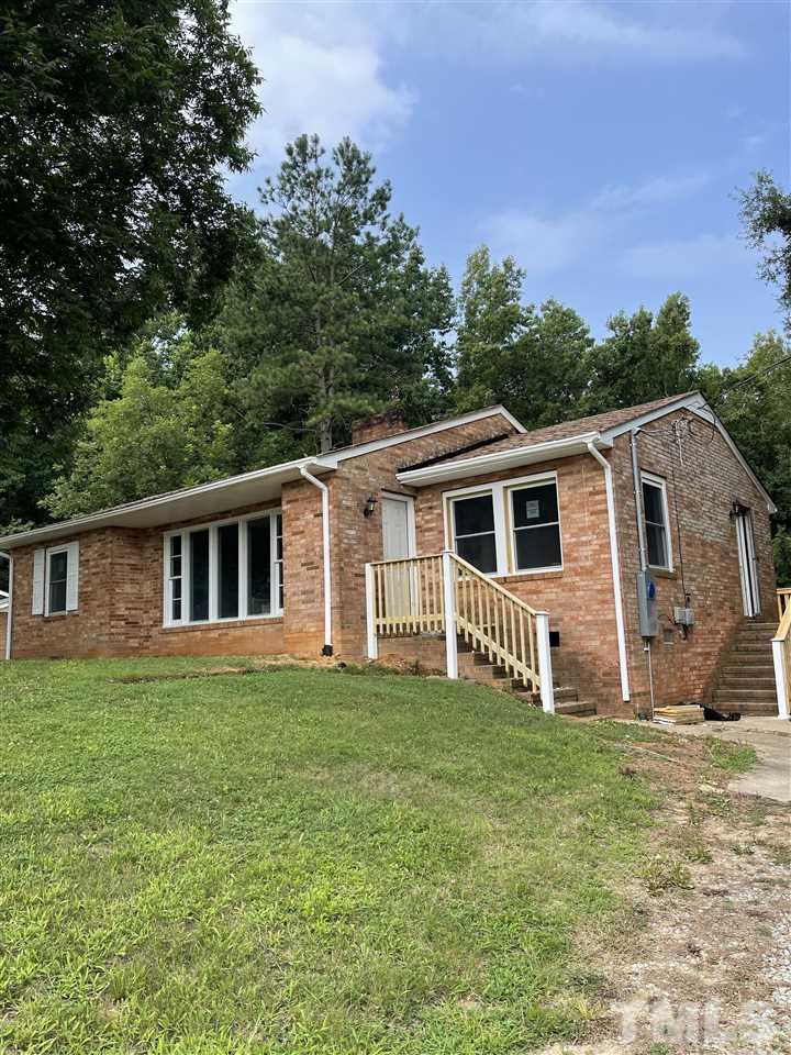 50 Henderson Road Roxboro, NC 27573 - Photo 1 of 6 a front view of a house with a garden