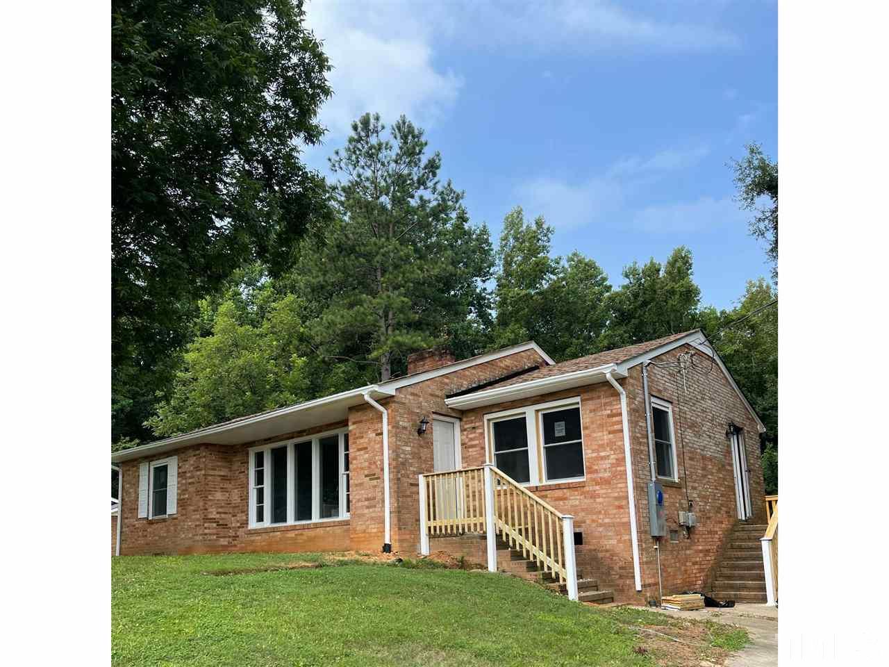 50 Henderson Road Roxboro, NC 27573 - Photo 2 of 6 a front view of a house with a yard