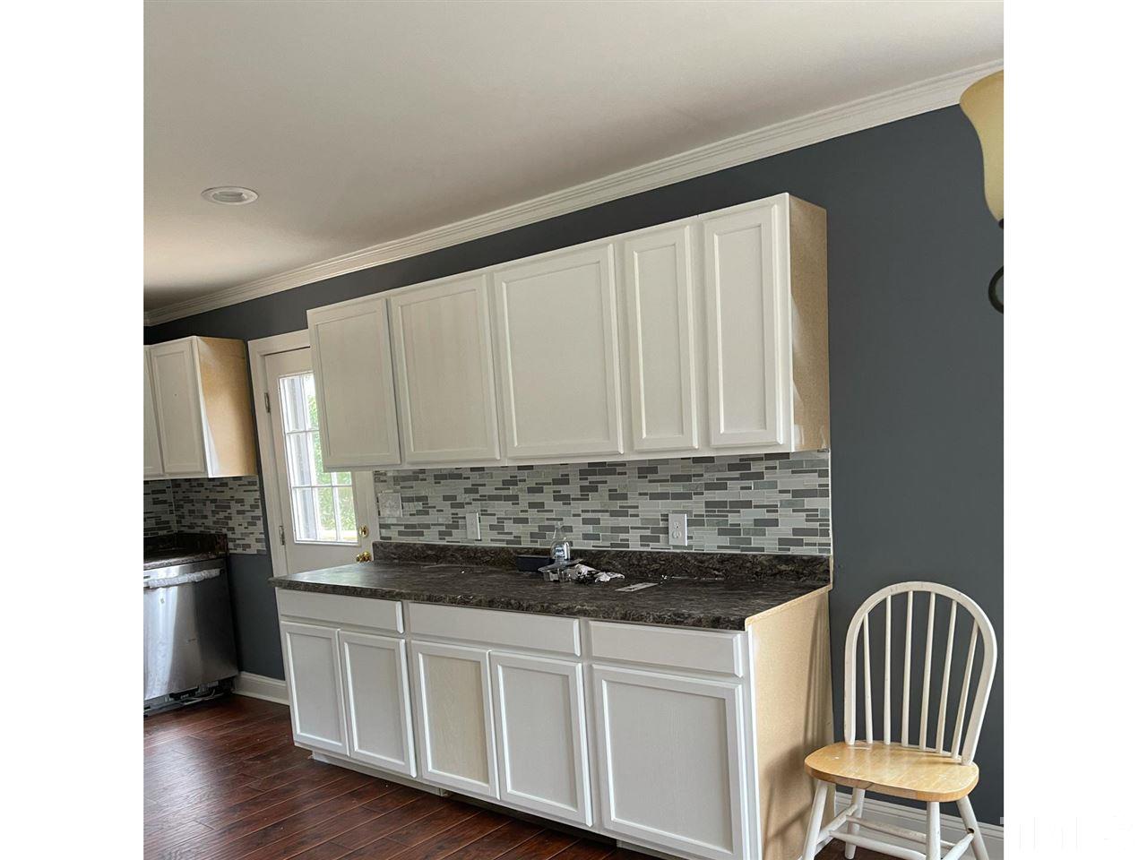50 Henderson Road Roxboro, NC 27573 - Photo 3 of 6 a kitchen with stainless steel appliances granite countertop a stove a sink and a refrigerator