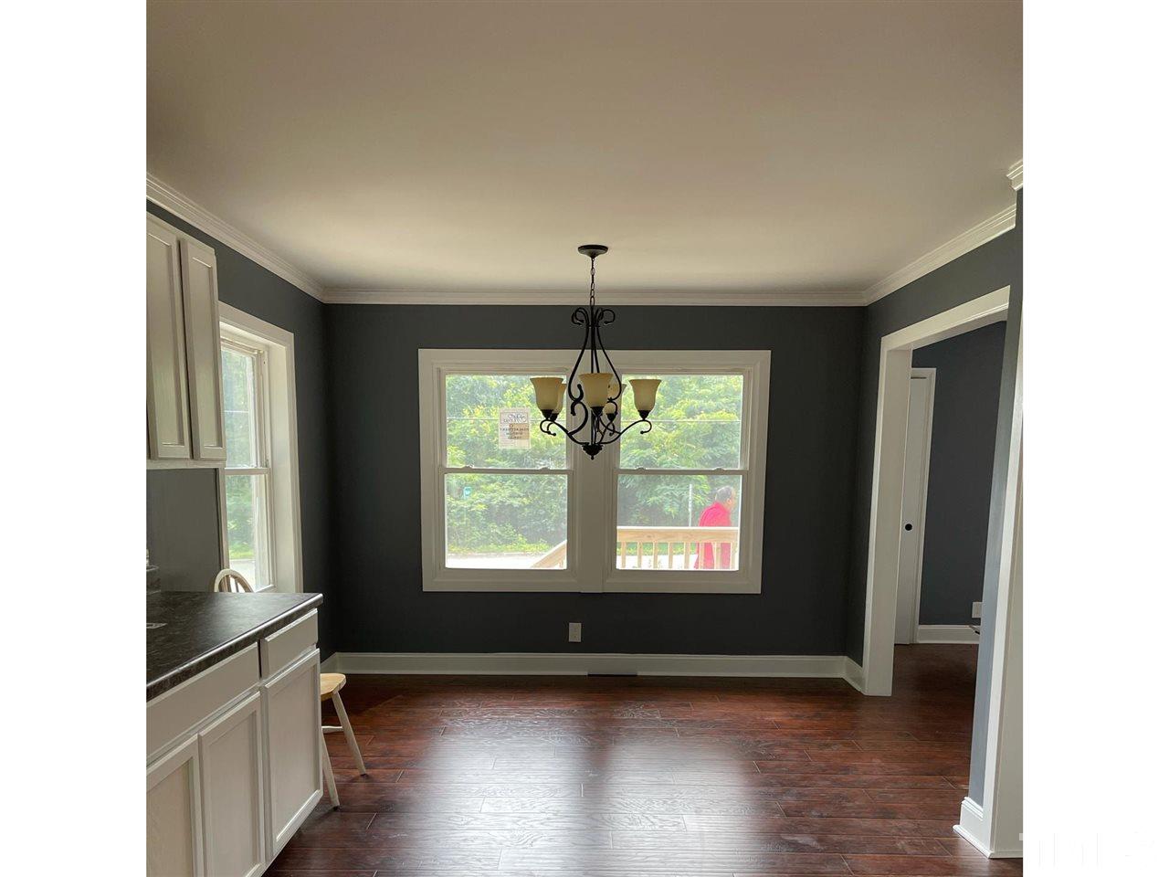 50 Henderson Road Roxboro, NC 27573 - Photo 6 of 6 a view of an empty room with wooden floor and a window