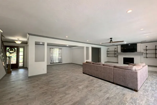 a living room with furniture and a kitchen view