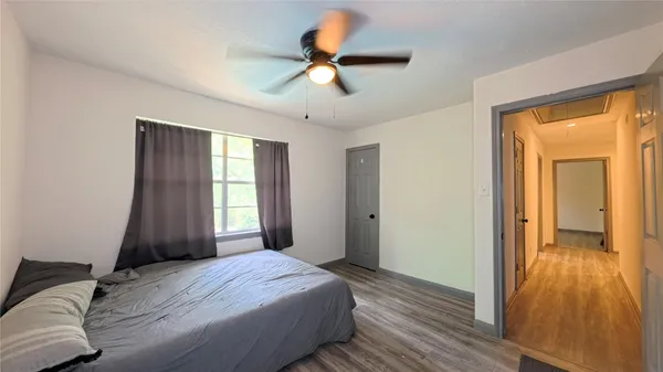 a bedroom with a bed and a large window