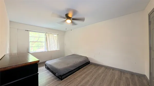 a living room with a bed furniture and a window