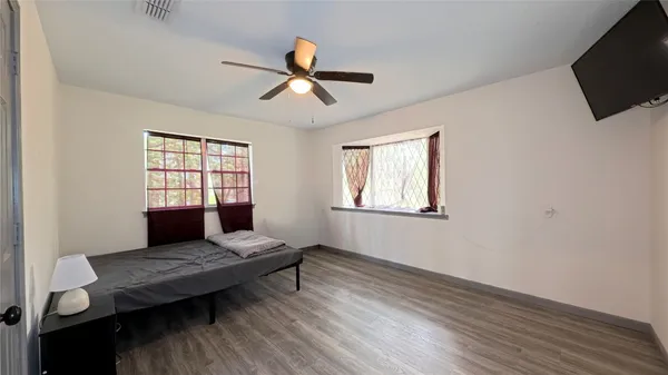 a living room with a flat screen tv and a window
