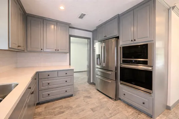 a kitchen with stainless steel appliances and granite counter tops