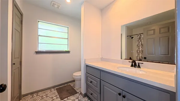 a bathroom with a sink a toilet and a mirror
