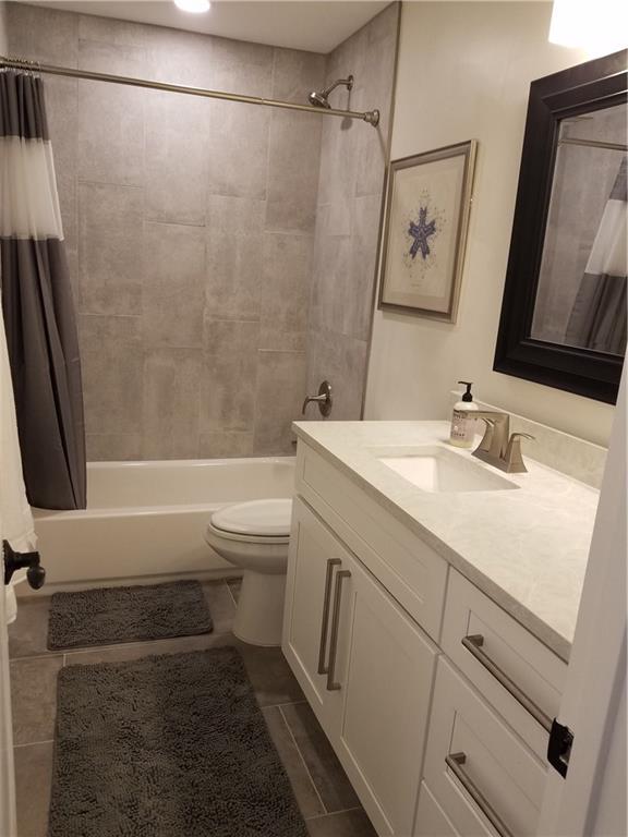 5405 Hudson Street Austin, TX 78721 - Photo 24 of 37 A pristine bathroom features a modern vanity with elegant countertops and a tiled shower-tub combination.