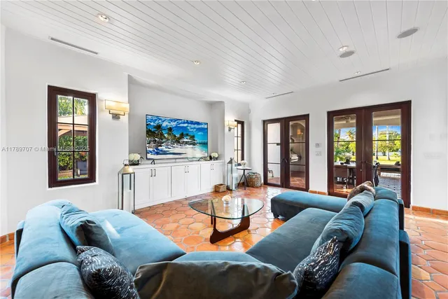 a living room filled with lots of furniture and a table