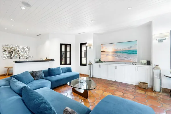 a living room filled with lots of furniture and a table