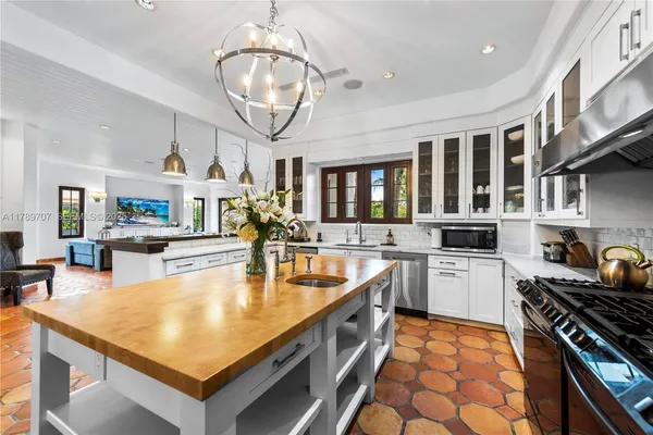 a dining room with furniture a rug and a chandelier