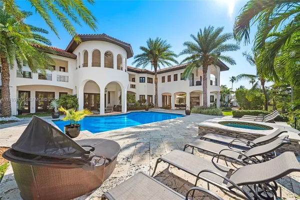 a front view of a house with yard and swimming pool