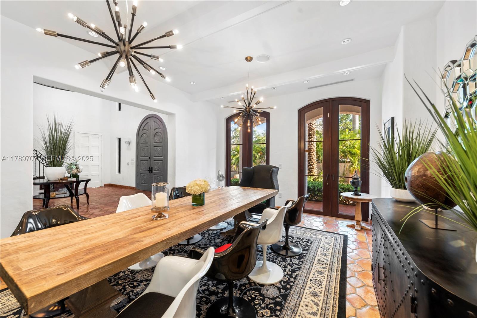 1201 Northeast 83rd Street Miami, FL 33138 - Photo 21 of 67 a dining room with furniture a rug and a chandelier