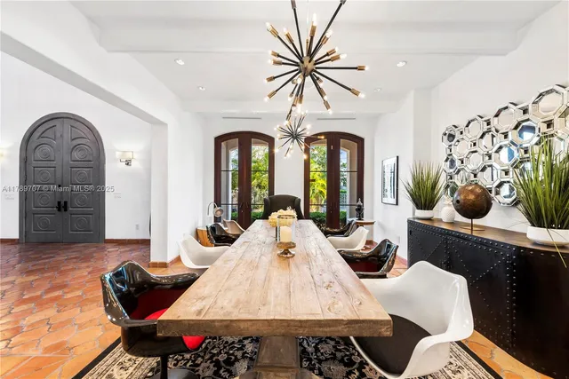 a living room with furniture wooden floor and a large window
