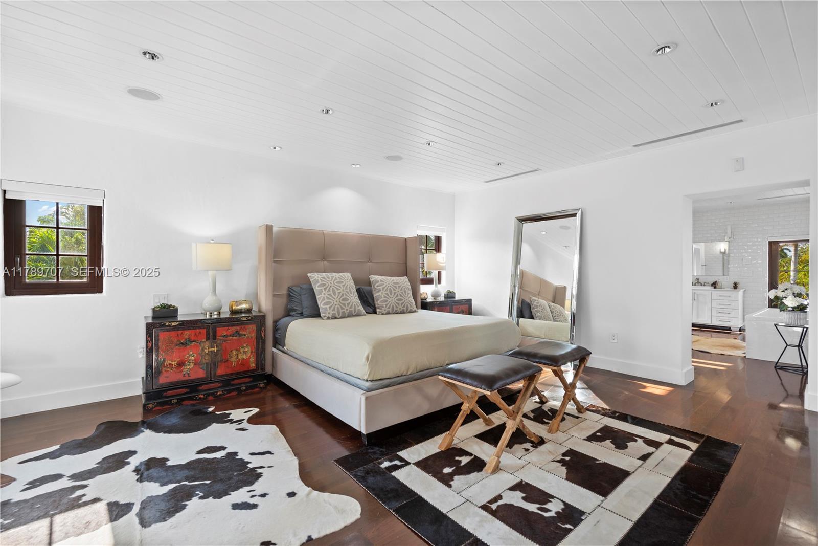 1201 Northeast 83rd Street Miami, FL 33138 - Photo 25 of 67 a bedroom with a bed and wooden floor