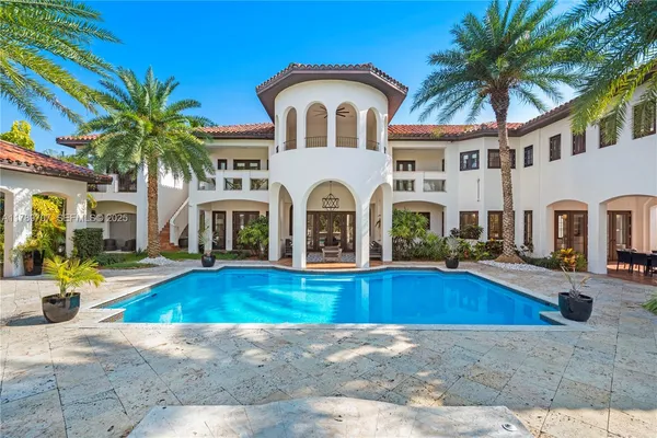 a view of house with swimming pool outdoor seating