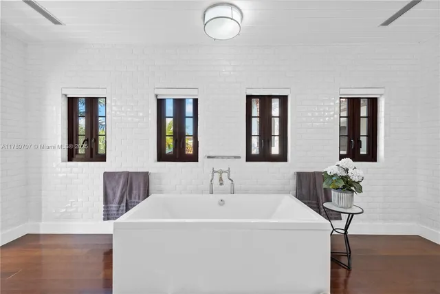 a bedroom with furniture and wooden floor