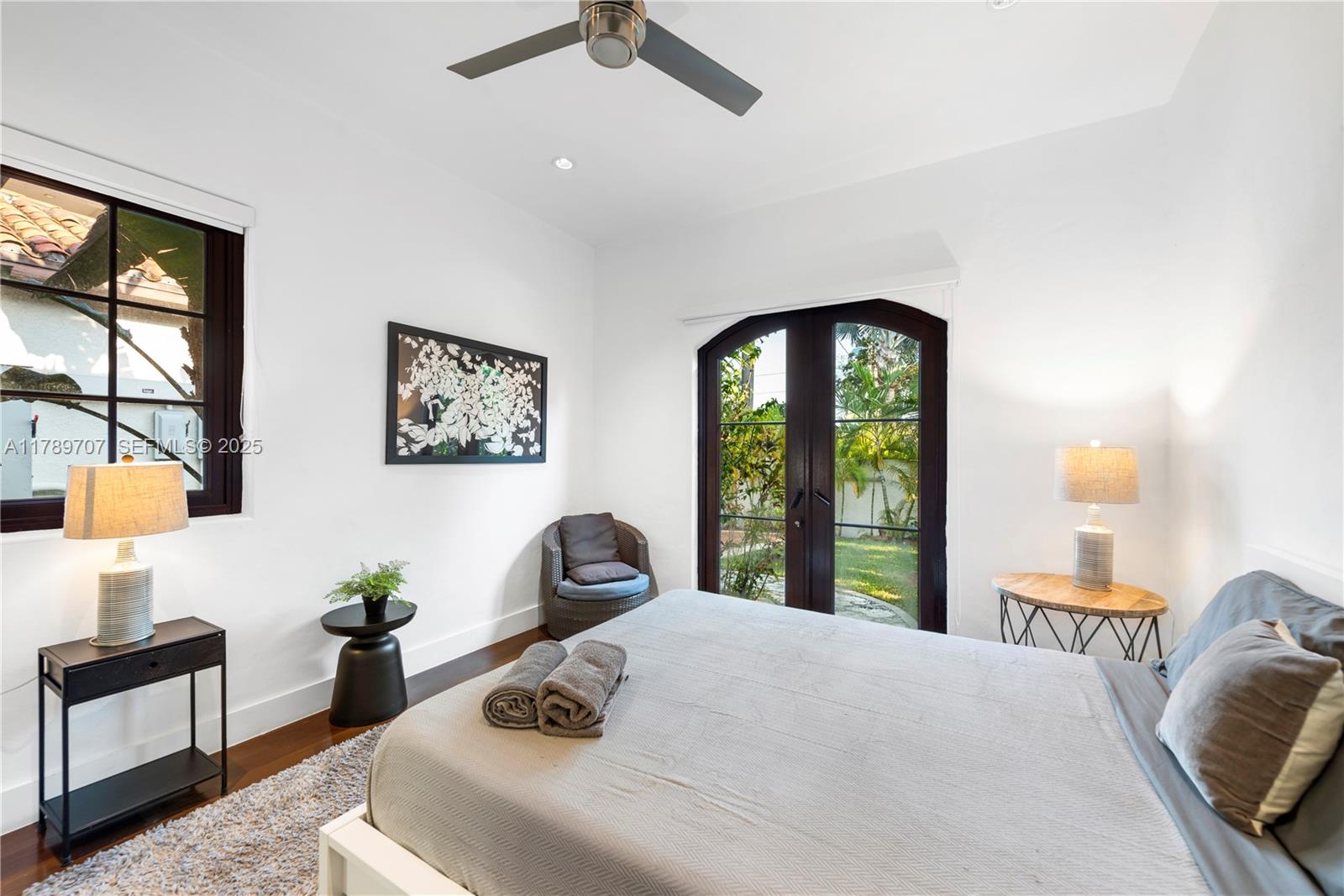 1201 Northeast 83rd Street Miami, FL 33138 - Photo 36 of 67 a bedroom with a bed and a large window