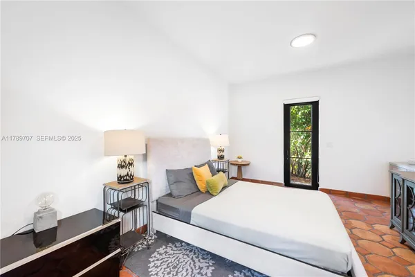 a bathroom with a granite countertop sink a toilet a mirror and shower