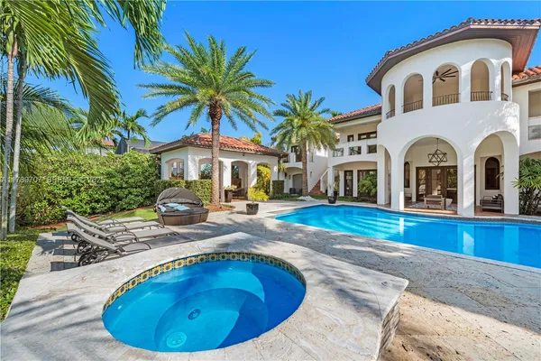 a living room with fireplace and a floor to ceiling window