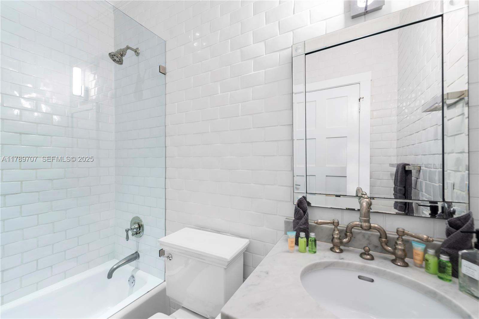 1201 Northeast 83rd Street Miami, FL 33138 - Photo 49 of 67 a bathroom with a sink mirror toilet and bathtub