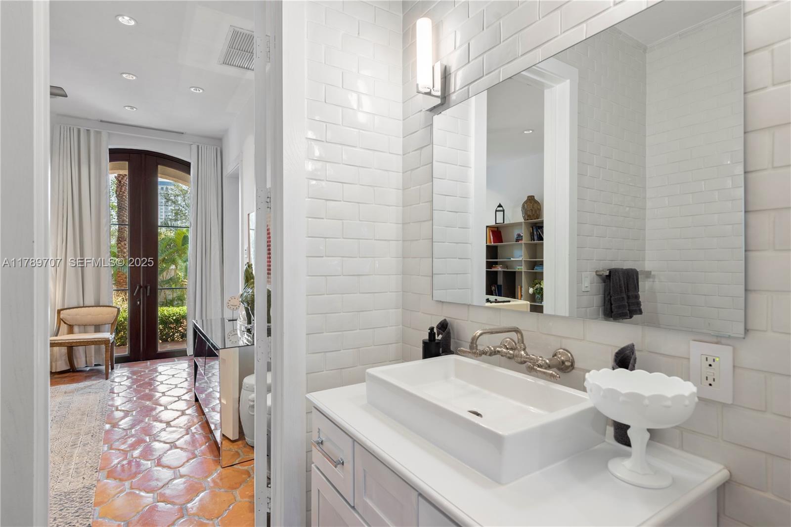 1201 Northeast 83rd Street Miami, FL 33138 - Photo 50 of 67 a en suite bathroom with a sink double vanity and a mirror