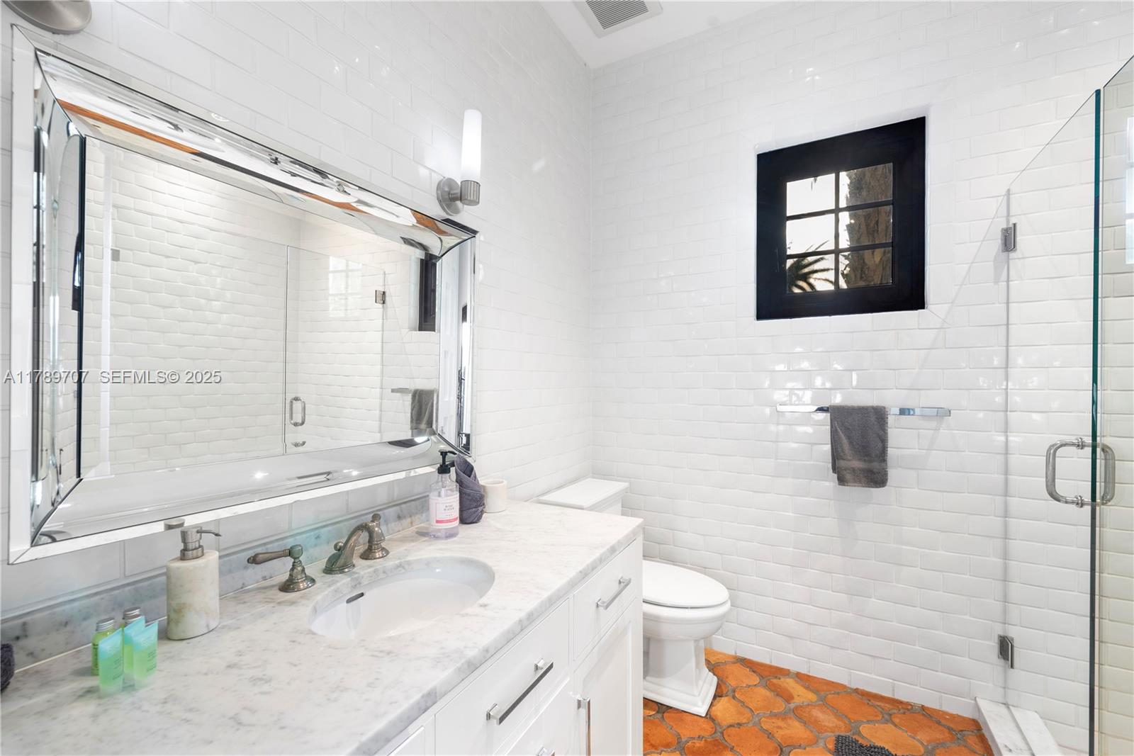 1201 Northeast 83rd Street Miami, FL 33138 - Photo 51 of 67 a bathroom with a granite countertop sink a toilet a mirror and shower