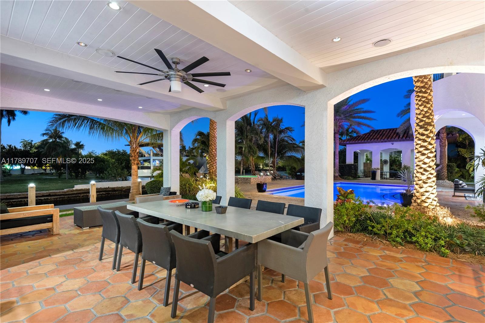 1201 Northeast 83rd Street Miami, FL 33138 - Photo 61 of 67 a dining room with furniture a kitchen and a chandelier
