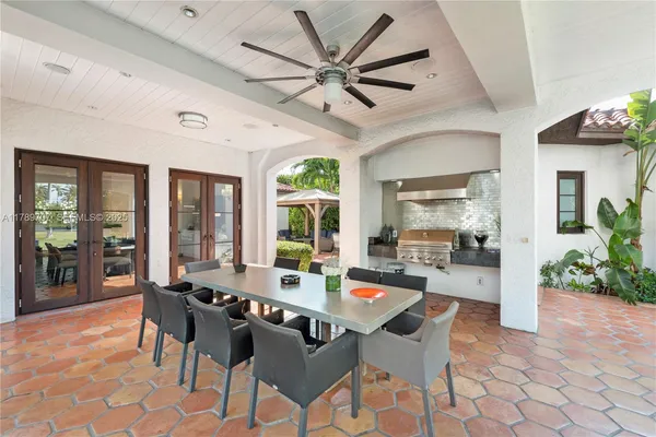 a living room with patio furniture and a large window