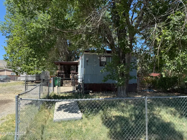 a view of a house with pool and sitting area
