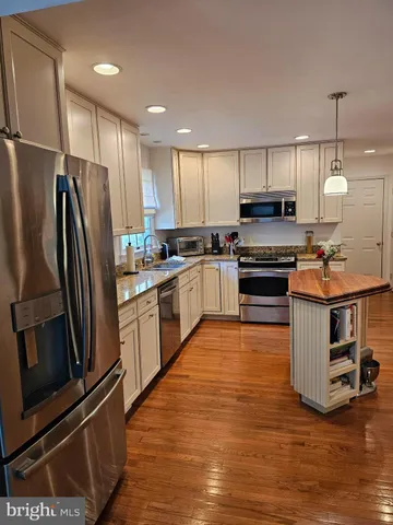 a kitchen with stainless steel appliances and wooden cabinets