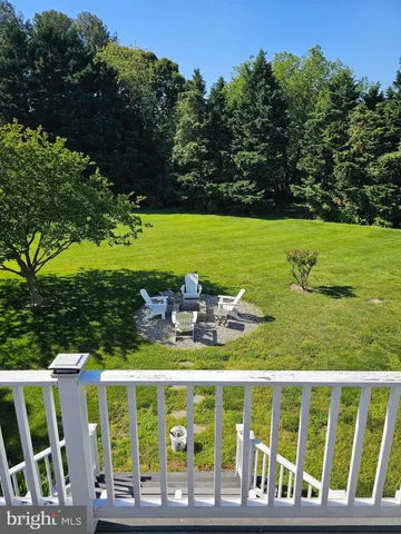a view of a wooden deck with a yard