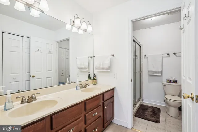 a bathroom with a sink double vanity and a toilet