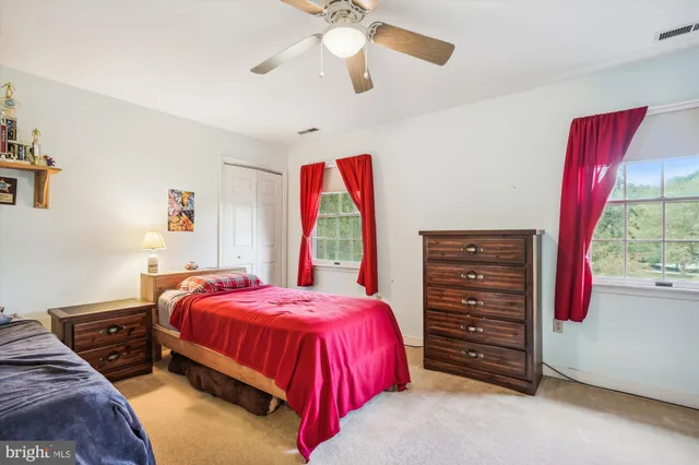 a bedroom with a bed and a dresser