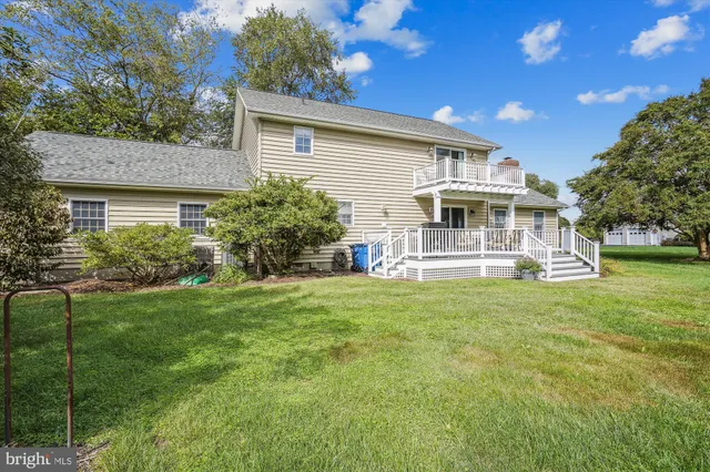 a view of a house with a backyard and a patio