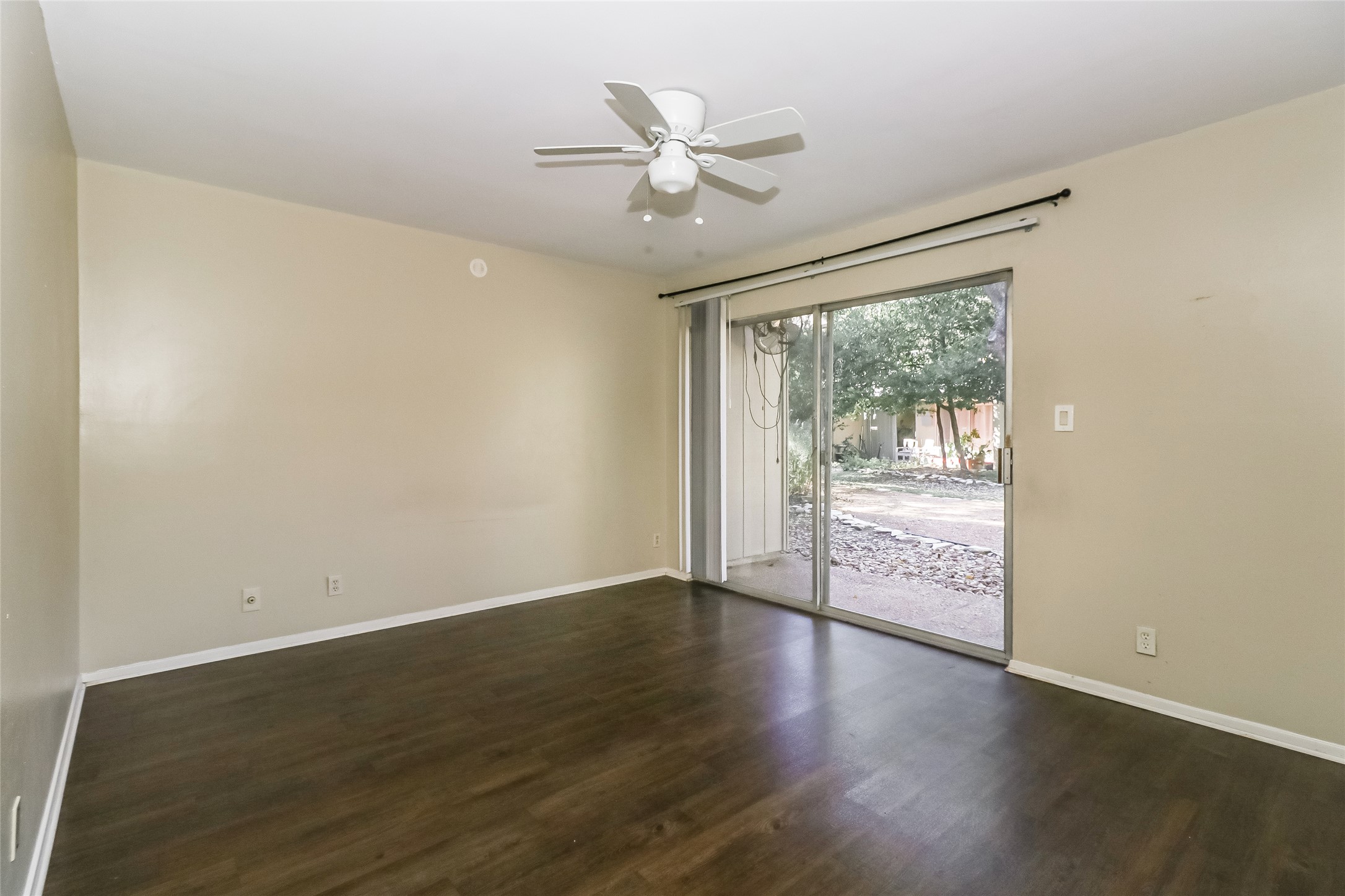 500 East Riverside Drive, Unit 135 Austin, TX 78704 - Photo 11 of 16 Spare room with dark wood-style floors and a ceiling fan