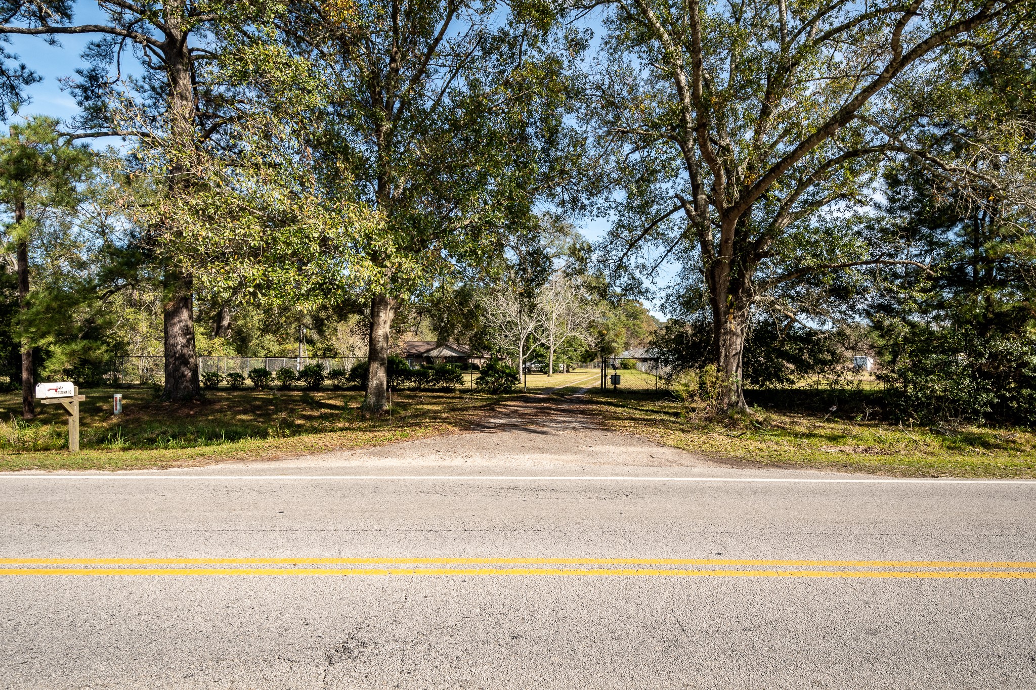 10488 Fostoria Road Cleveland, TX 77328 - Photo 12 of 16 a view of a house with a large tree and a yard