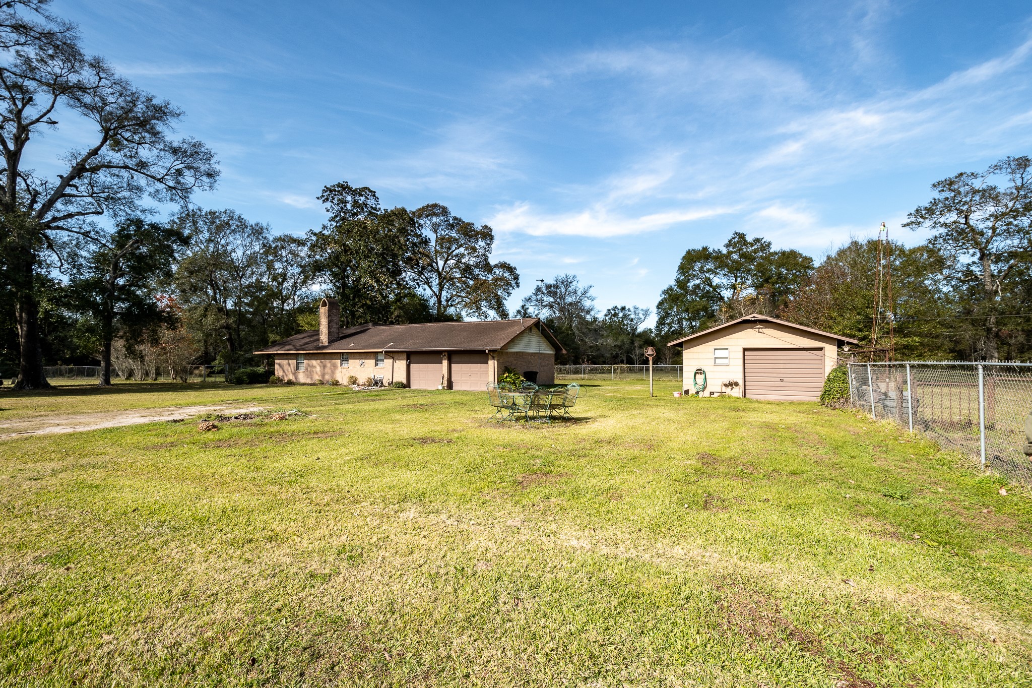 10488 Fostoria Road Cleveland, TX 77328 - Photo 3 of 16 a front view of a house with a yard and trees