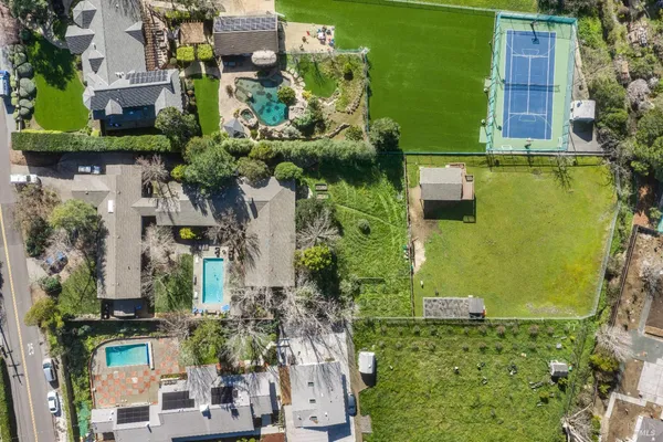 an aerial view of a house with a yard