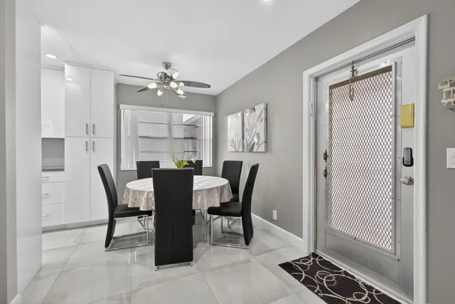 a view of a dining room with furniture and a chandelier fan
