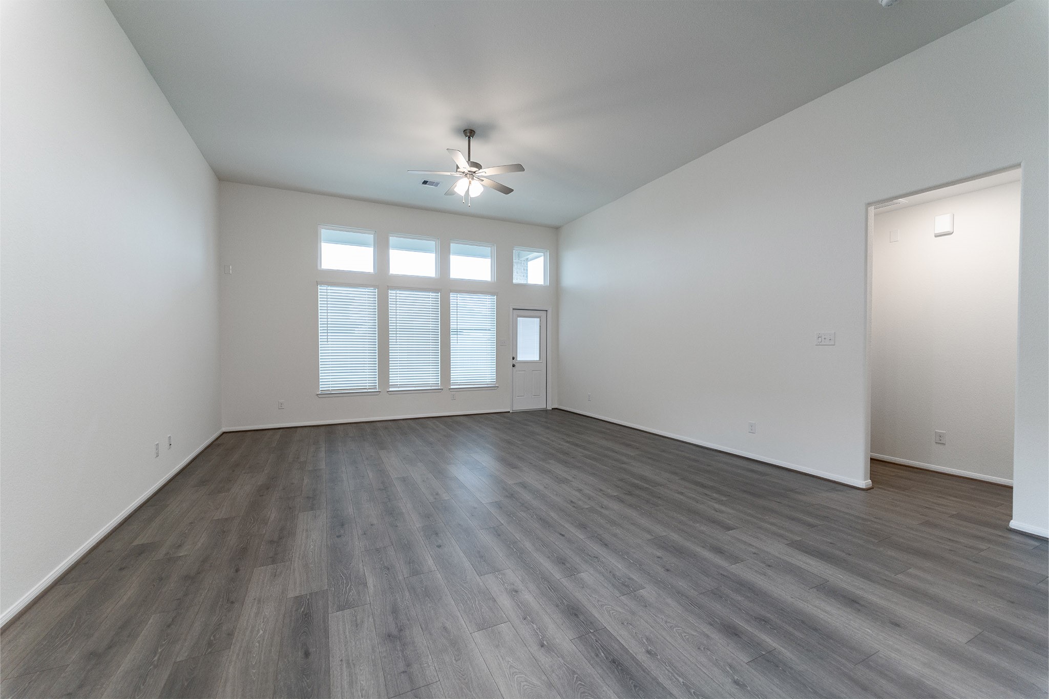 1923 Parks Edge Lane Angleton, TX 77515 - Photo 11 of 25 an empty room with wooden floor and windows