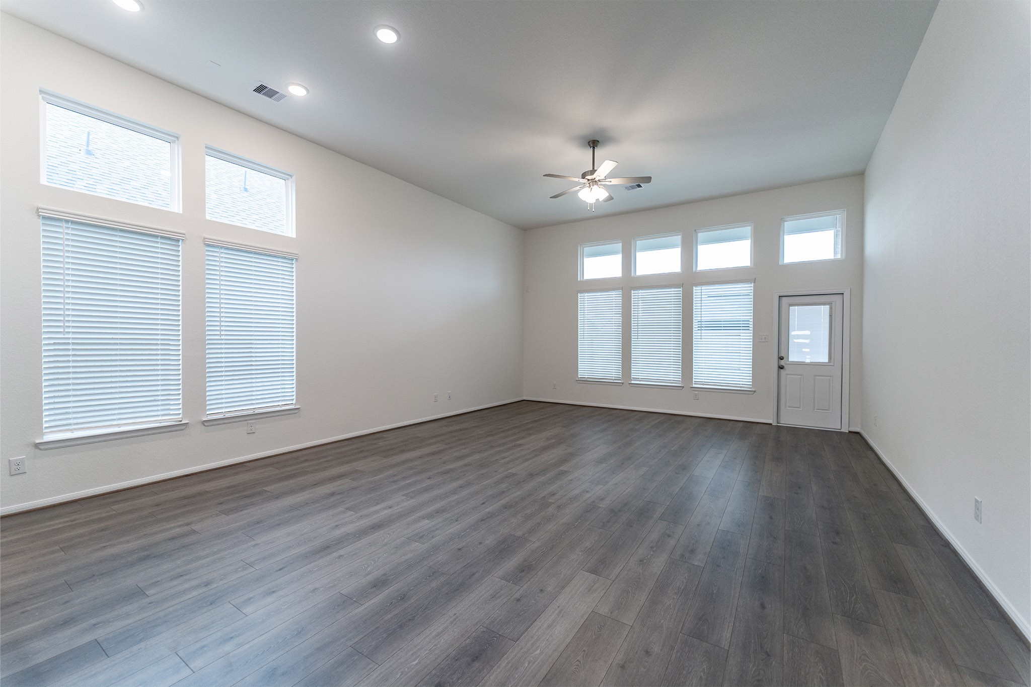 1923 Parks Edge Lane Angleton, TX 77515 - Photo 12 of 25 an empty room with wooden floor and windows