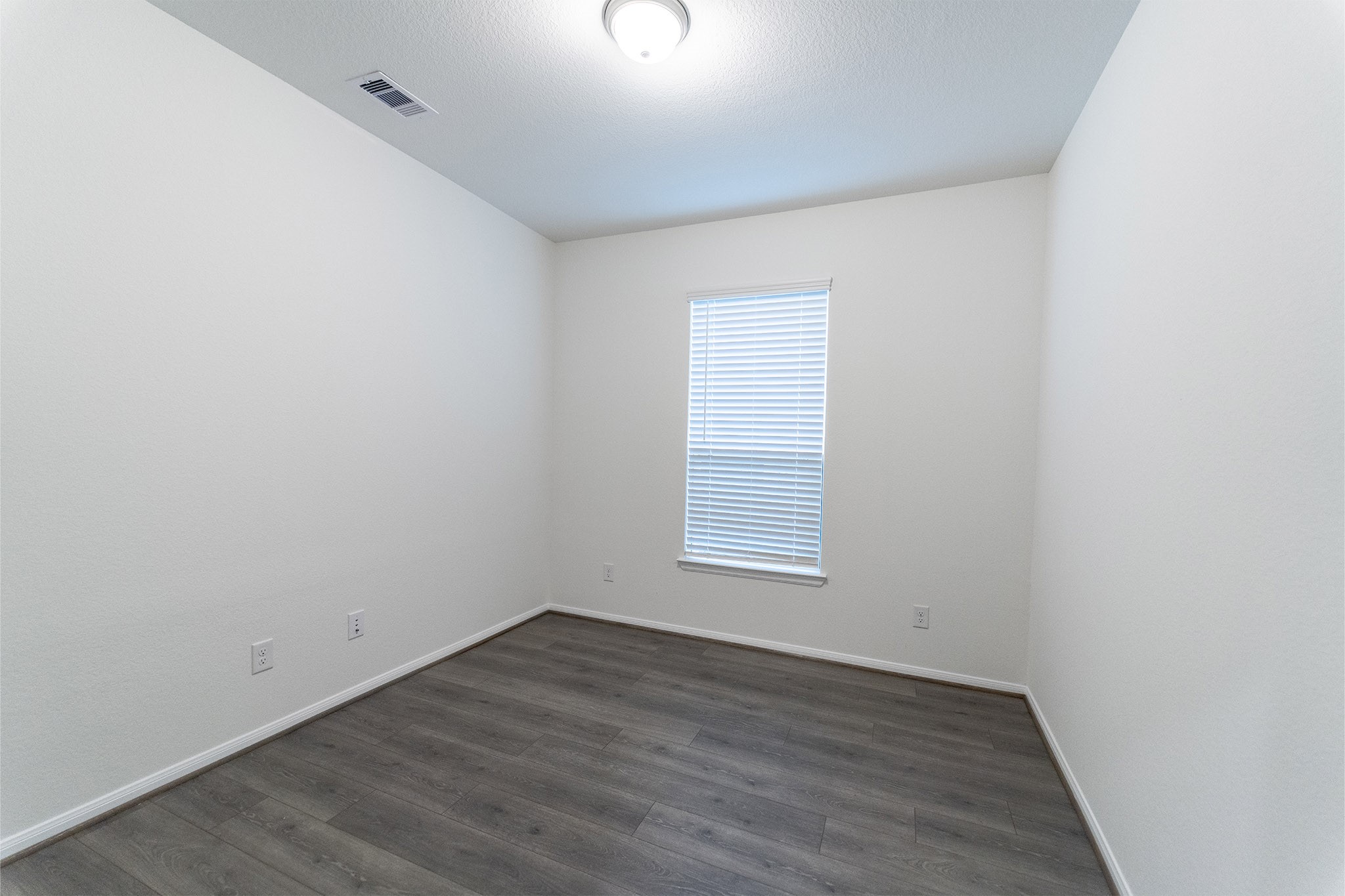 1923 Parks Edge Lane Angleton, TX 77515 - Photo 20 of 25 an empty room with wooden floor and windows