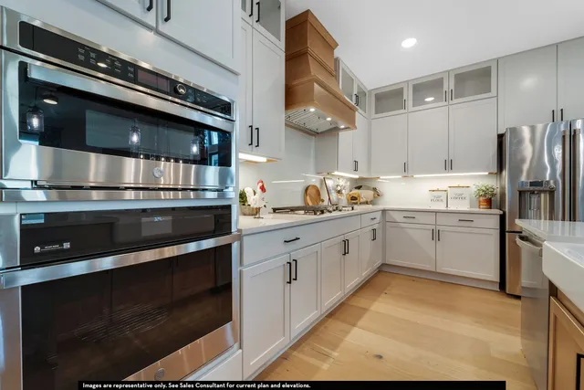 a kitchen with stainless steel appliances and white cabinets