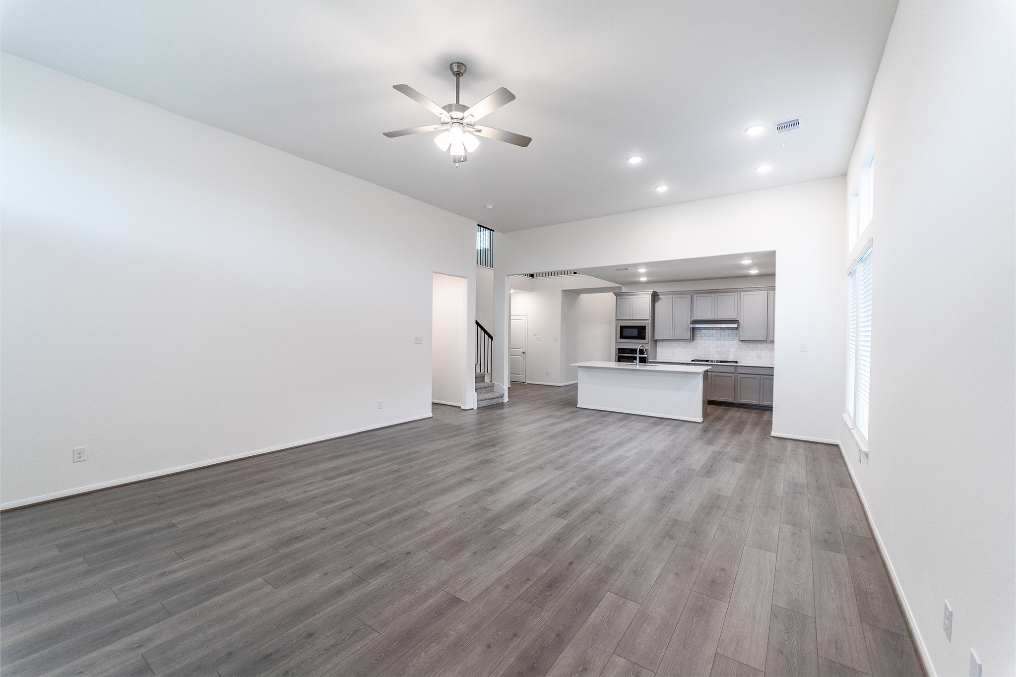 1923 Parks Edge Lane Angleton, TX 77515 - Photo 4 of 25 a view of a hallway with wooden floor and a kitchen