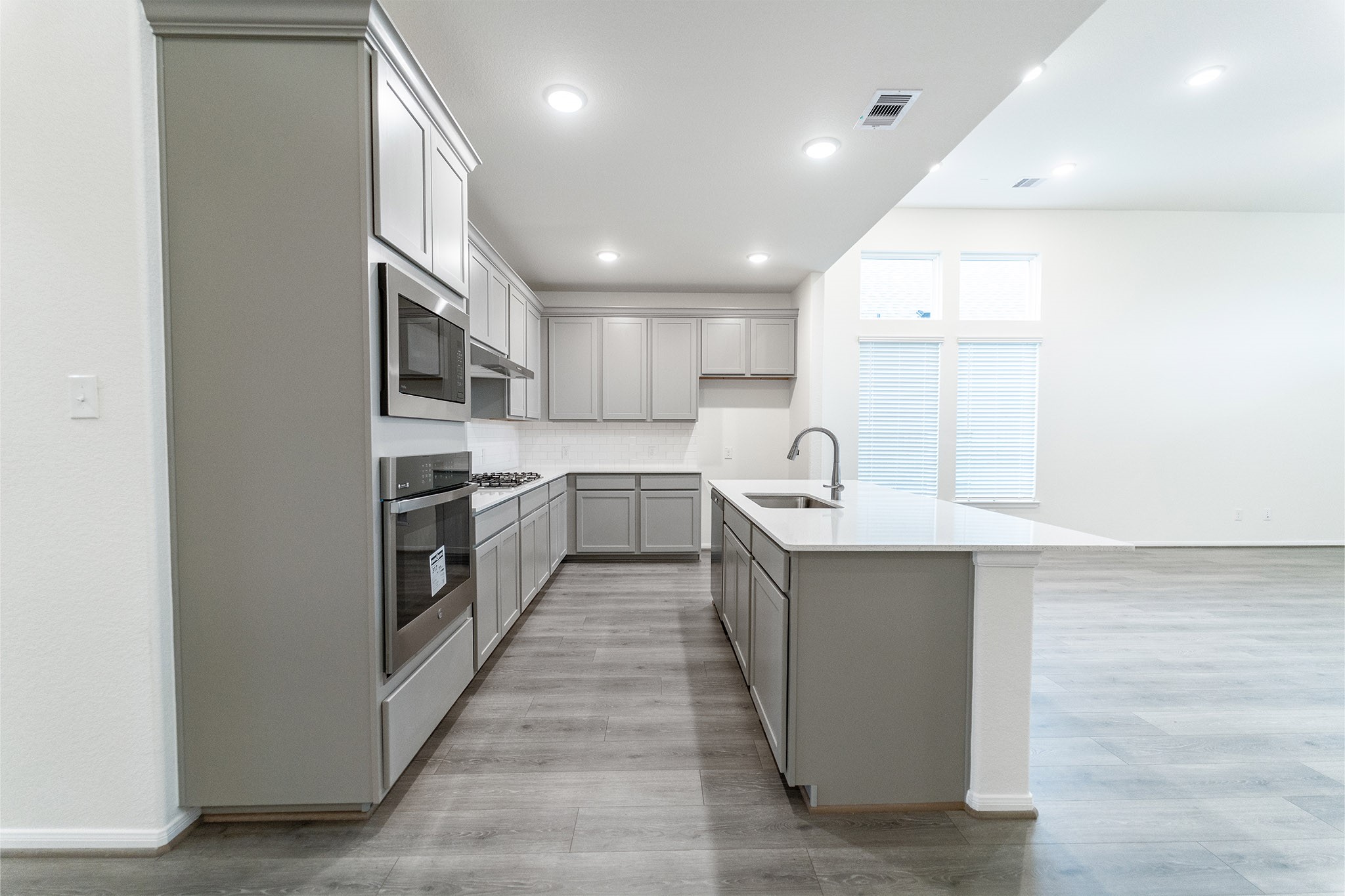 1923 Parks Edge Lane Angleton, TX 77515 - Photo 5 of 25 a kitchen with a sink a counter top space stainless steel appliances and cabinets