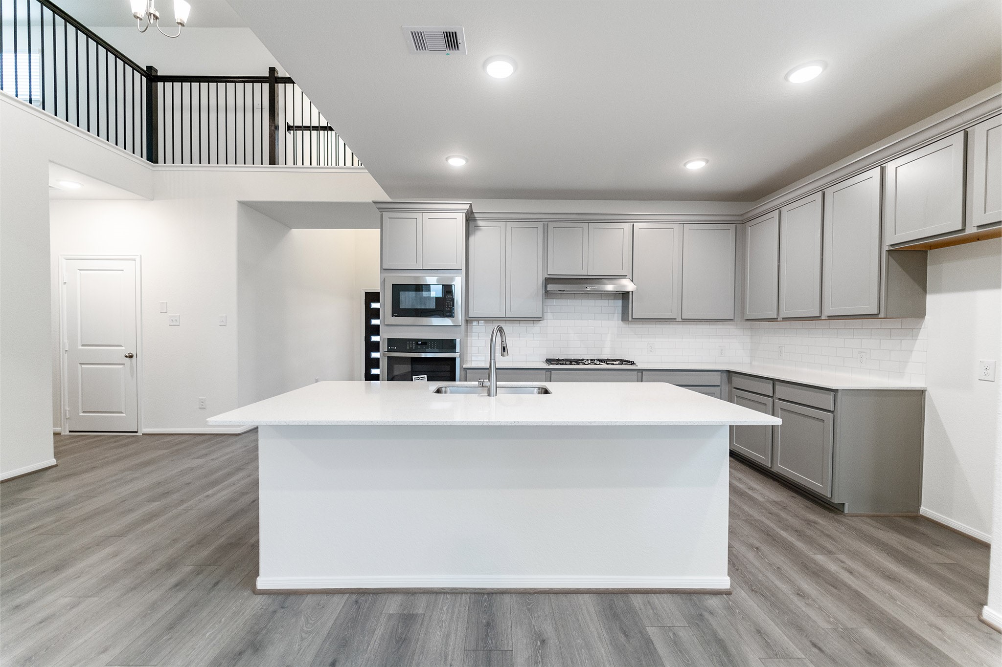 1923 Parks Edge Lane Angleton, TX 77515 - Photo 8 of 25 a kitchen with kitchen island a stove a sink and a refrigerator