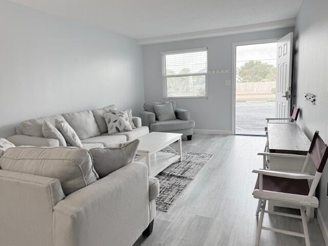 885 Santa Rosa Boulevard, Unit 111A Fort Walton Beach, FL 32548 - Photo 2 of 16 a living room with furniture and a window