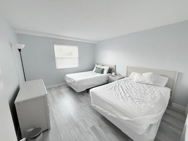 885 Santa Rosa Boulevard, Unit 111A Fort Walton Beach, FL 32548 - Photo 4 of 16 a bedroom with two beds and a window