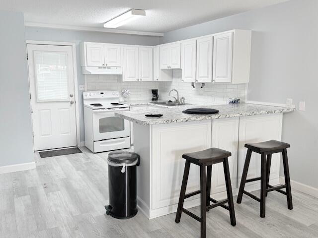 885 Santa Rosa Boulevard, Unit 111A Fort Walton Beach, FL 32548 - Photo 5 of 16 a kitchen with stainless steel appliances granite countertop white cabinets and chairs